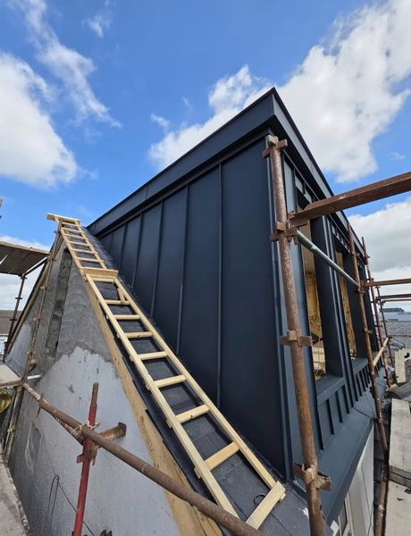 Zinc dormer extension under construction with scaffolding