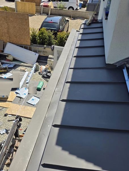 Close-up of standing seam zinc roof detailing during installation